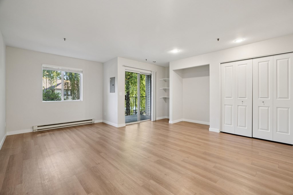 A room with wooden floors and white walls.