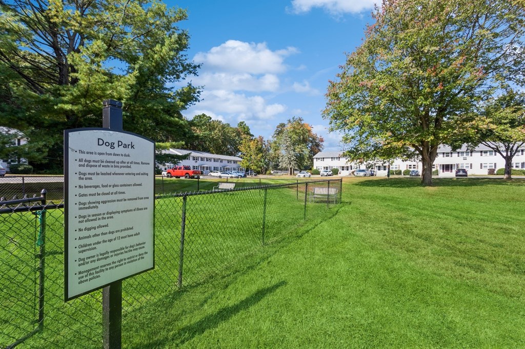a dog park with a dog park rules sign in front of a fence at Fox Hill Commons, Vernon, CT, 06066