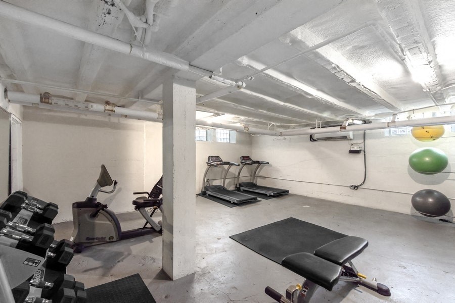 A gym with weights and a treadmill