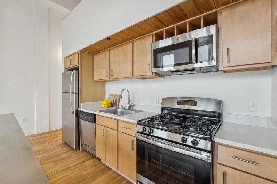 A kitchen with wooden cabinets and stainless steel appliances.