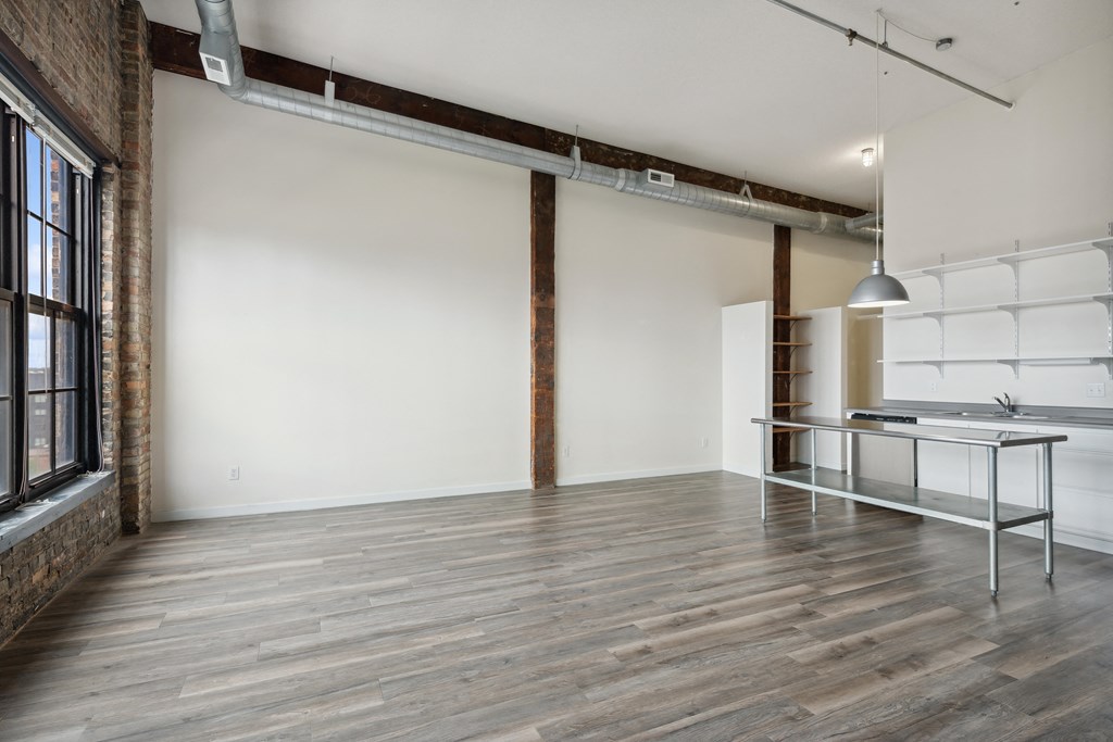 an empty room with white walls and wood floorsat Gaar Scott Historic Lofts, Minneapolis, 55401