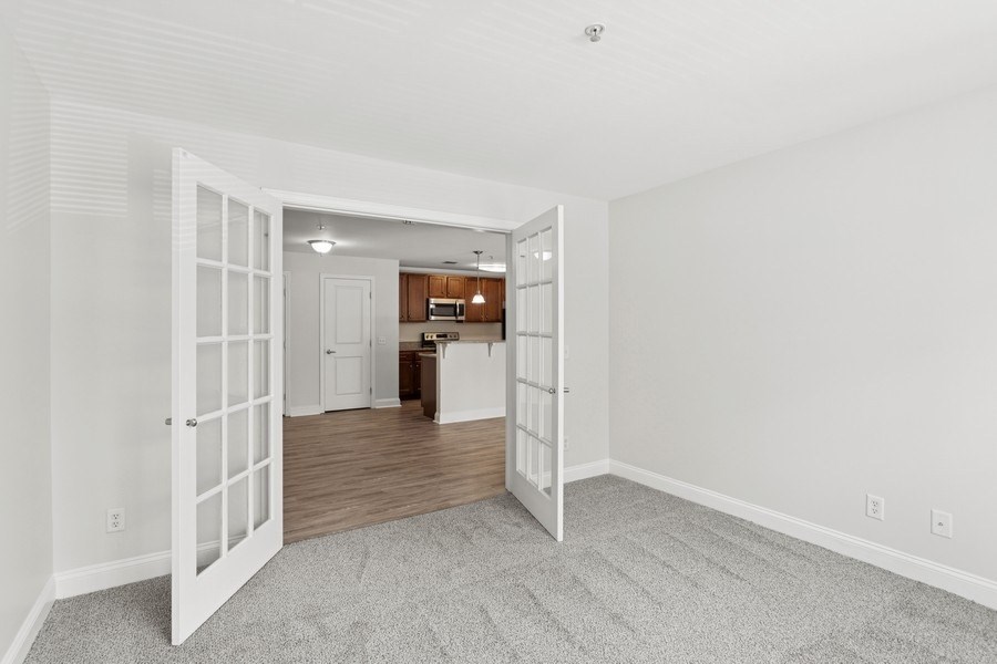 A room with a white door leading to another room.