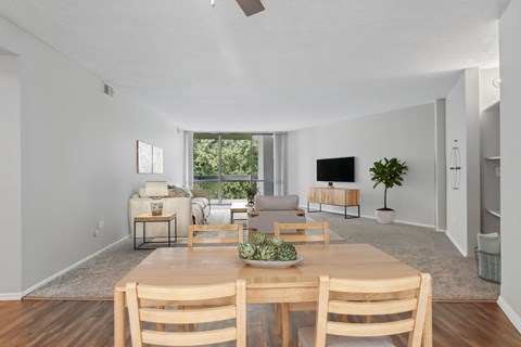 A dining room with a wooden table and chairs.