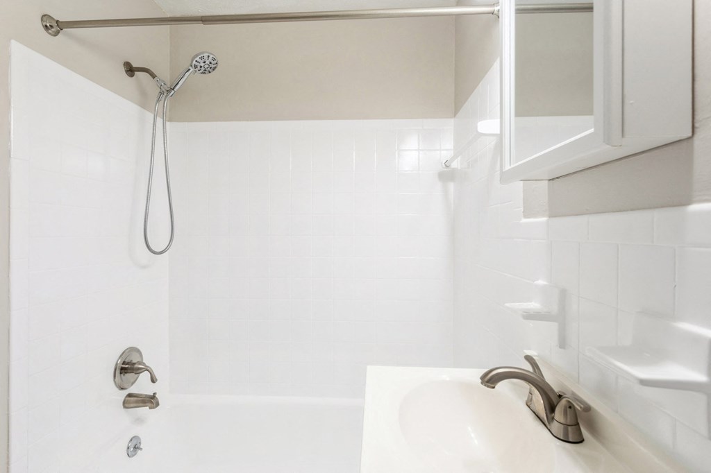 a white bathroom with a shower and a sink at Stonebridge, Ellington, CT, 06029