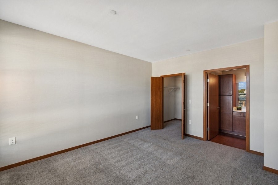 bedroom with a carpet and a door in it