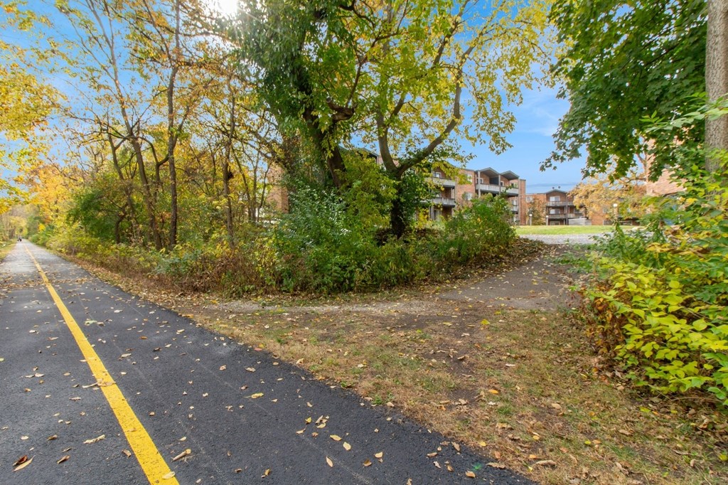 a path with trees on the side of a road at River Oaks, North Aurora, IL, 60542