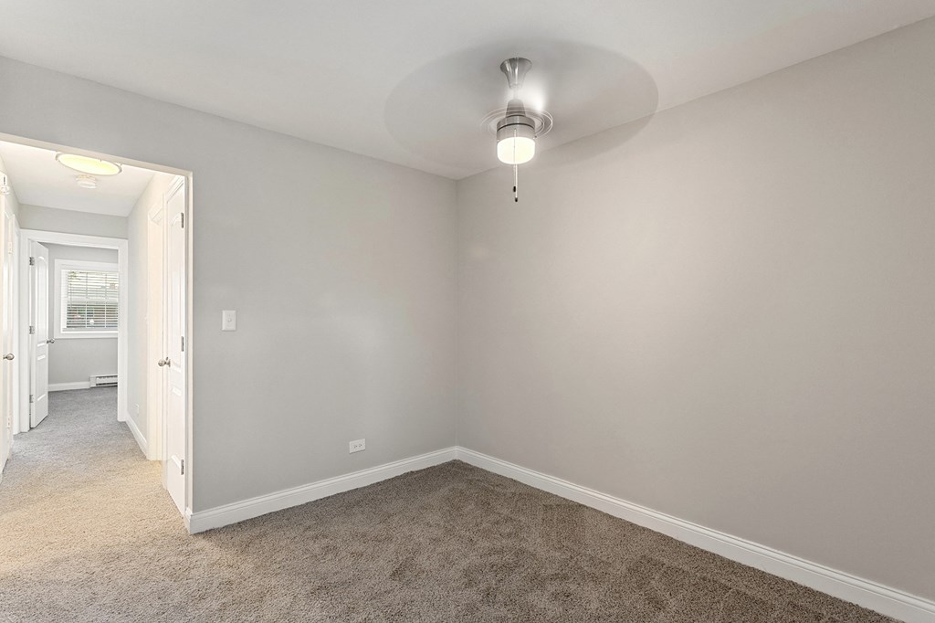 a bedroom with gray walls and carpet at The Hinsdale, Illinois