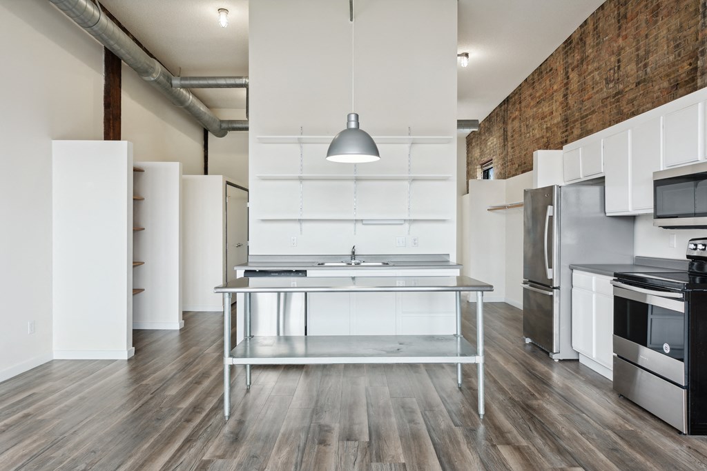 a kitchen with white cabinetry and stainless steel appliancesat Gaar Scott Historic Lofts, Minnesota