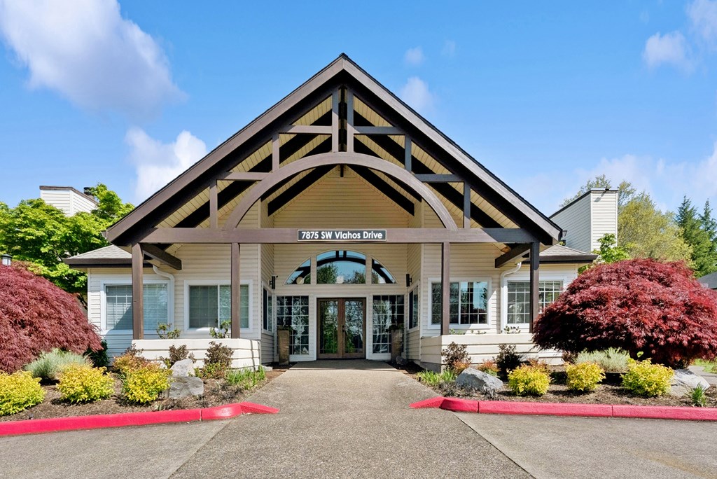 The front of a building with a red carpet leading to the entrance.