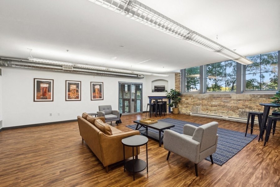 Room with sofa, wood floors, and chairs