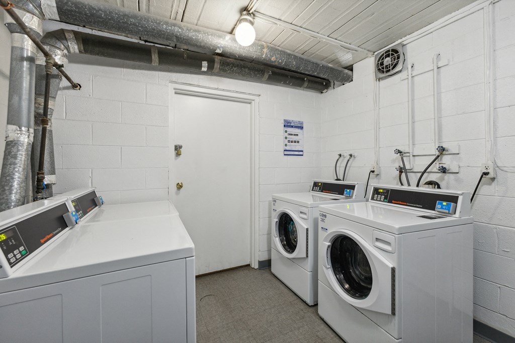 a laundry room with two washes and two dryers at Briarwood Apartments, Dumfries, VA, 22026