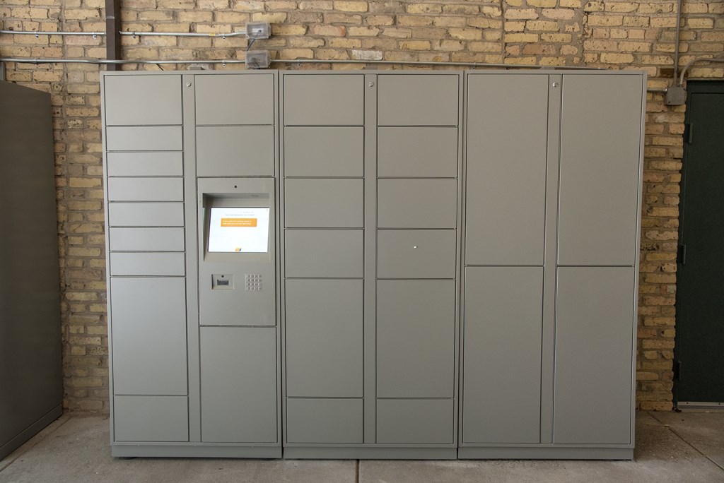 A grey electrical box with a yellow warning label on the front.