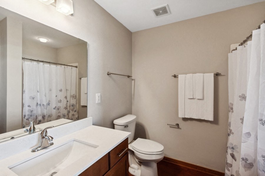 a bathroom with a sink toilet and a mirror