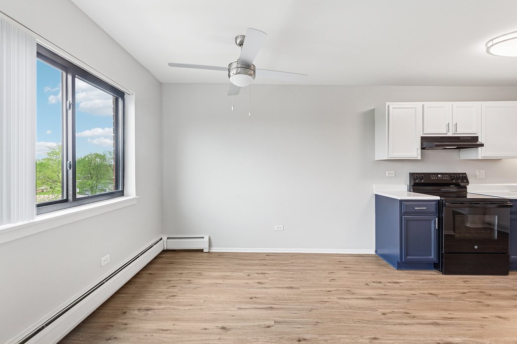 A kitchen with a blue oven and white cabinets.