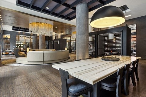 a dining room with a table and chairs in front of a wine cellar