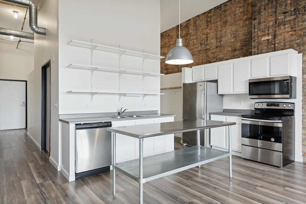 a kitchen with white cabinetry and stainless steel appliancesat Gaar Scott Historic Lofts, Minnesota, 55401
