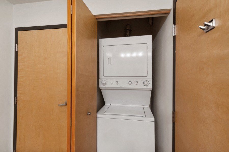 an empty laundry room with a washer and dryer