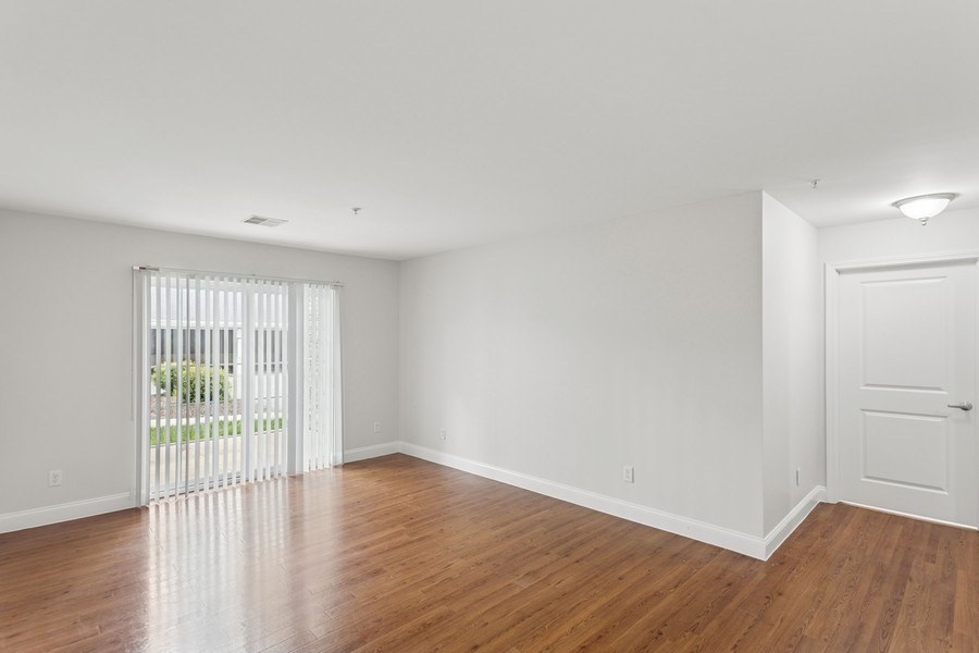 A room with wooden floors and white walls.