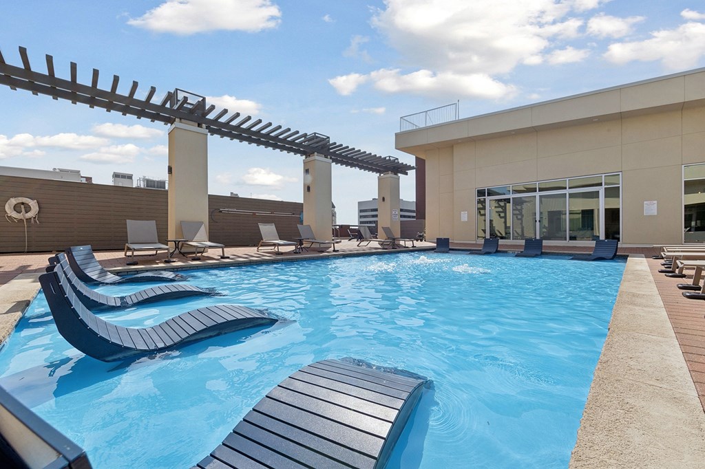 Rooftop pool with sun loungers.