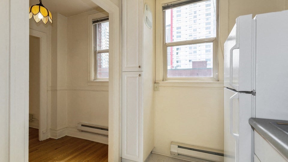a kitchen with a refrigerator and a window