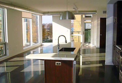 A modern kitchen with a large island and a sink.