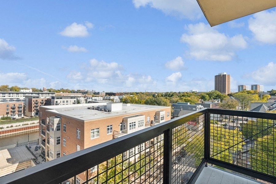 the view of the city from the balcony of an apartment building