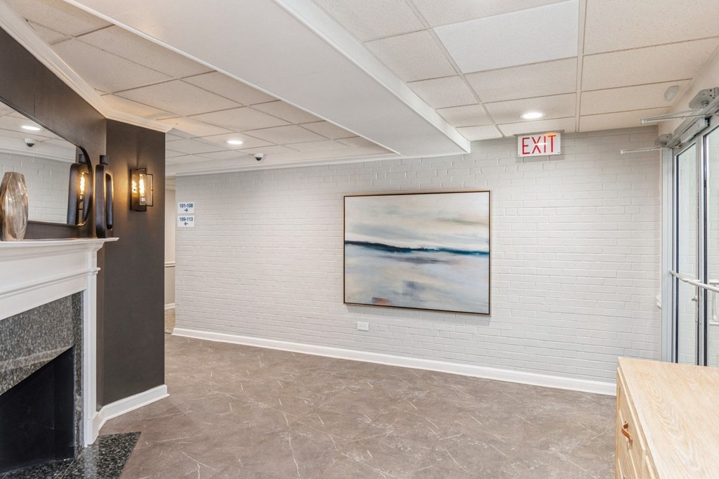 A room with a fireplace and a painting on the wall.