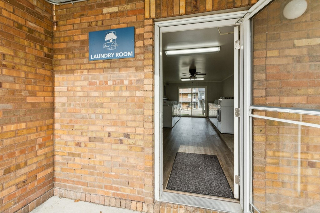 the door to the laundry room is open in a brick building at River Oaks, North Aurora, Illinois