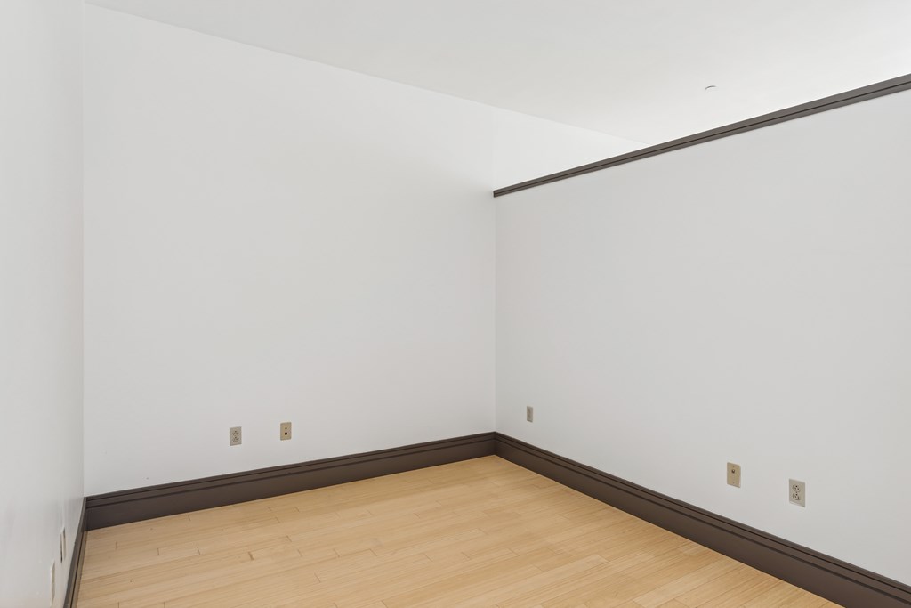 A room with white walls and a wooden floor.