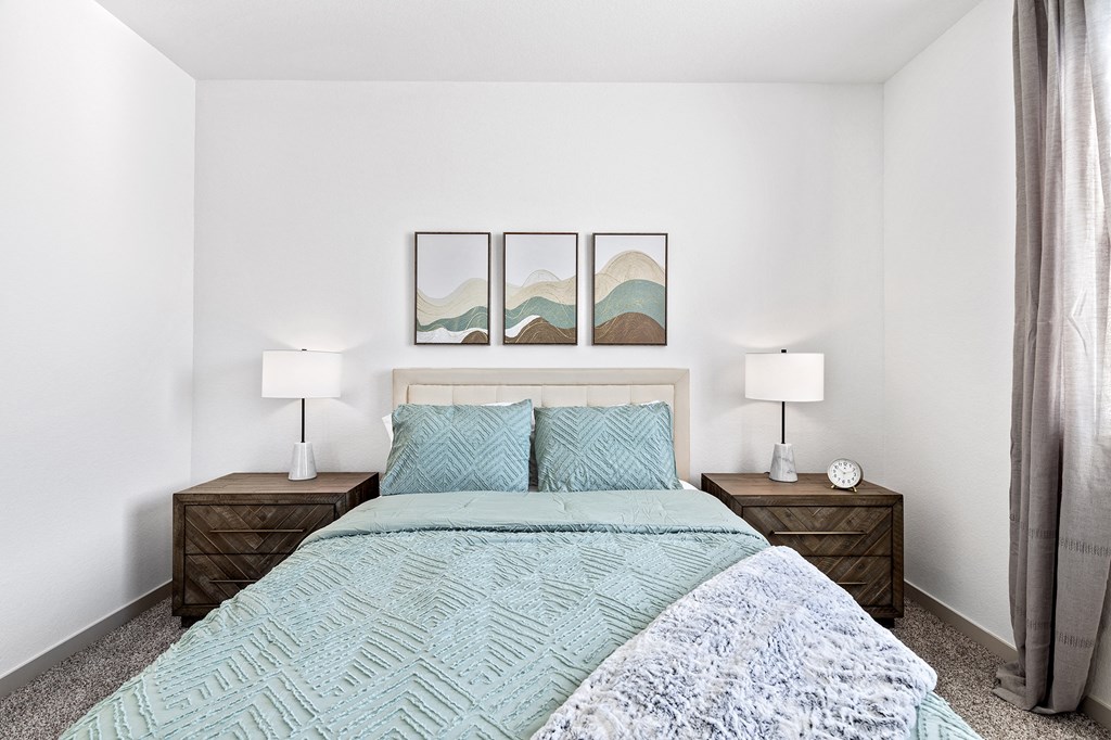 a bedroom with a bed and two night stands with lamps