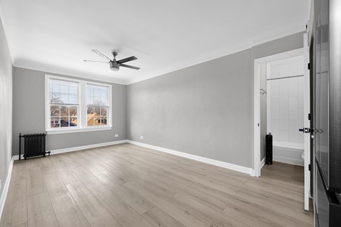 A room with a ceiling fan and a window with a view at Pleasant Oak Apartments, Oak Park, 60302