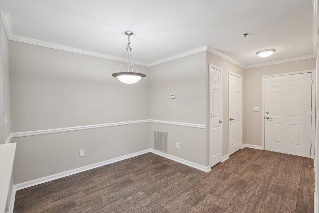 A living room with wooden floors and white walls.