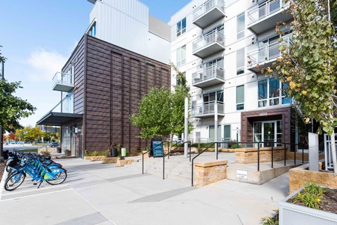 Bike share station and apartment building exterior at 1800 Lake Apartments, Minnesota, 55408