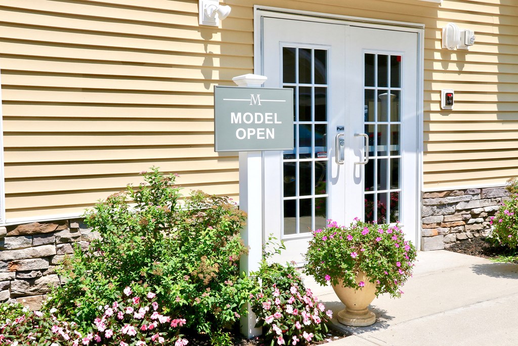 a model open sign in front of a building