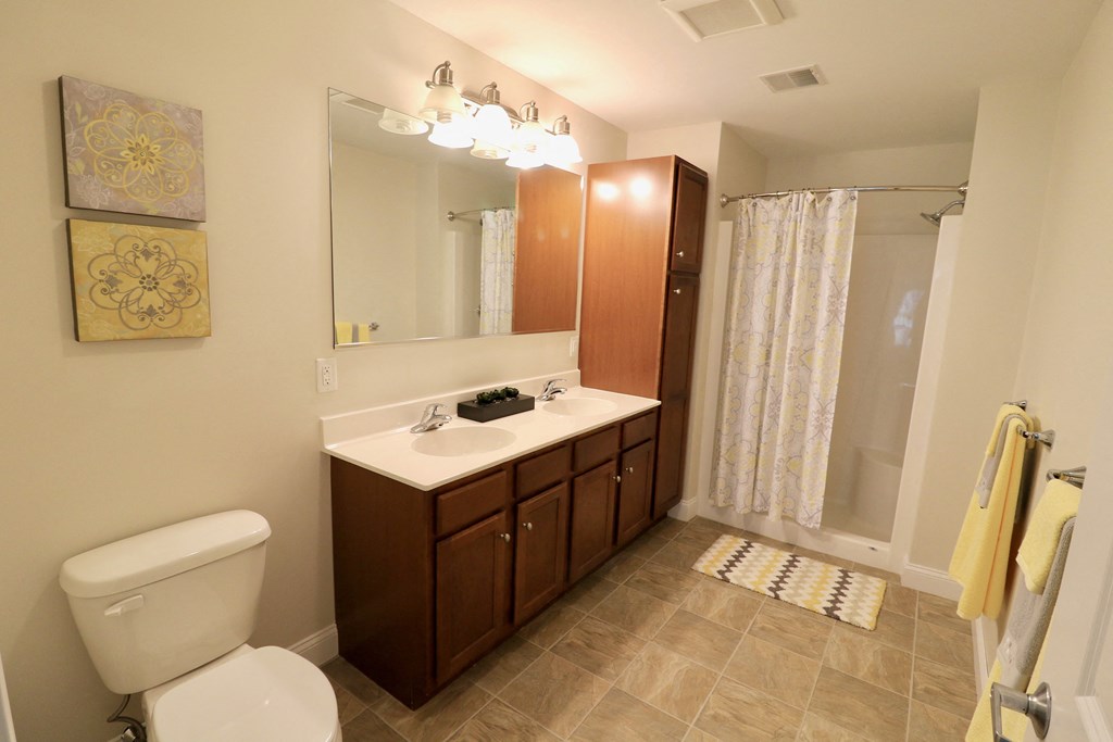 a bathroom with a toilet sink and a mirror