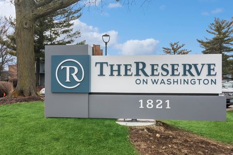 a sign for the reserve in front of a tree