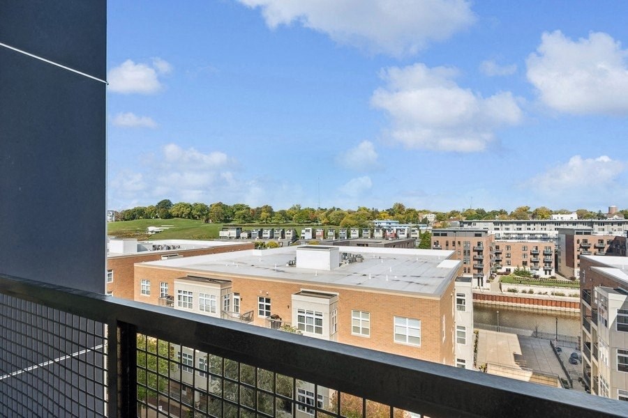 the view of the city from the balcony of an apartment building