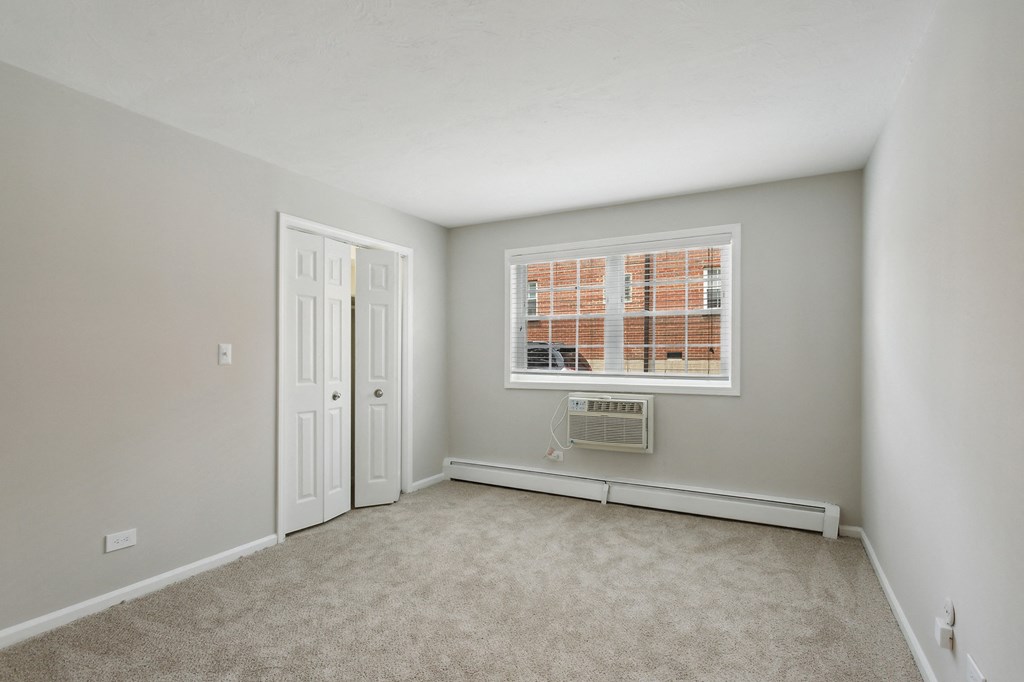 a bedroom with grey walls and carpet at The Hinsdale, Hinsdale, 60521