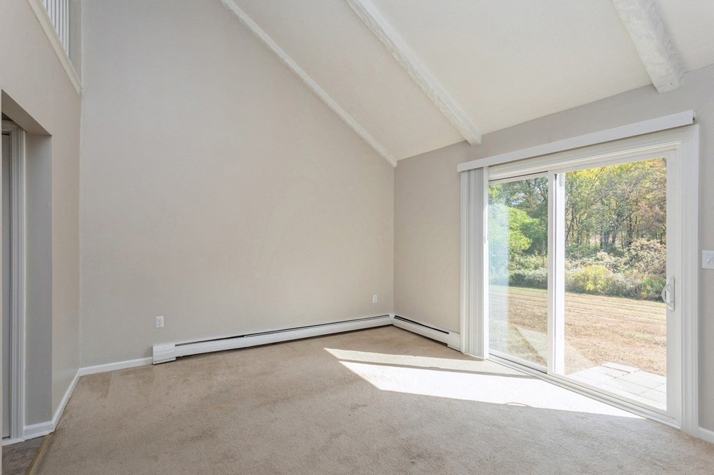 Empty carpeted room with sliding doors
