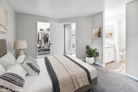A bedroom with a large bed and a view of a hallway and closet.