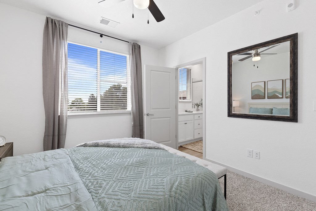 a bedroom with a bed and a large window