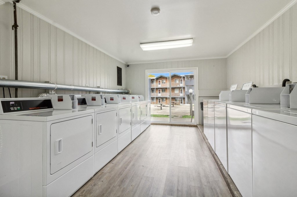 laundry room with washer and dryers and a door to a building in the at River Oaks, North Aurora, IL, 60542