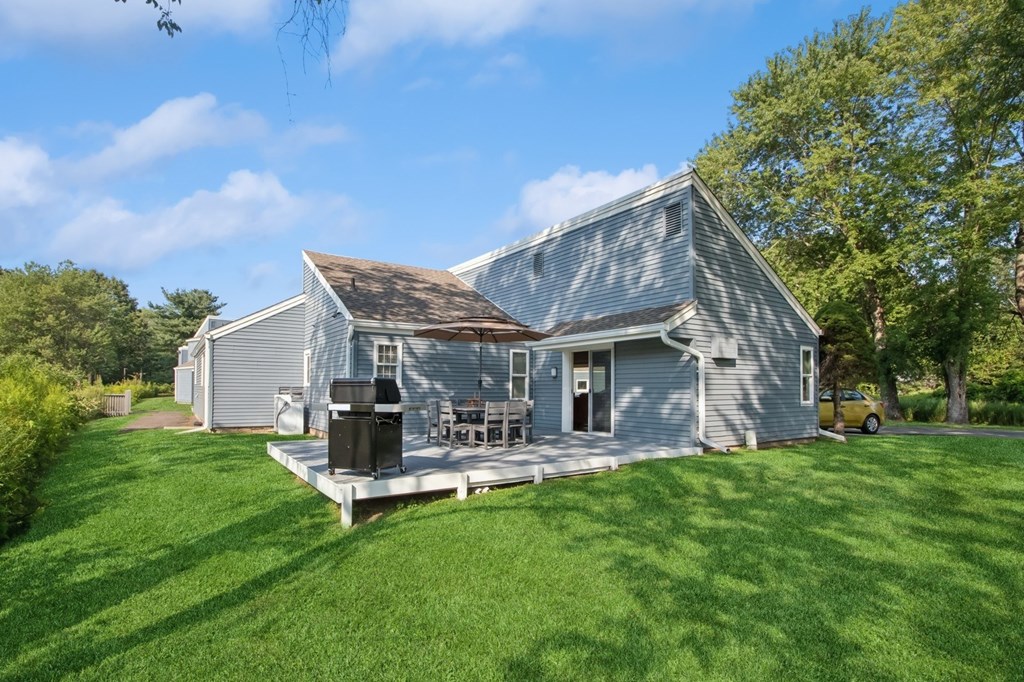 A house with a grey roof and a white fence.