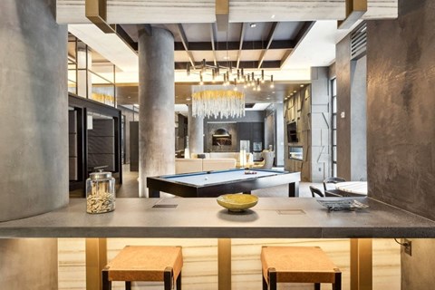 a kitchen and living room with a pool table and a chandelier