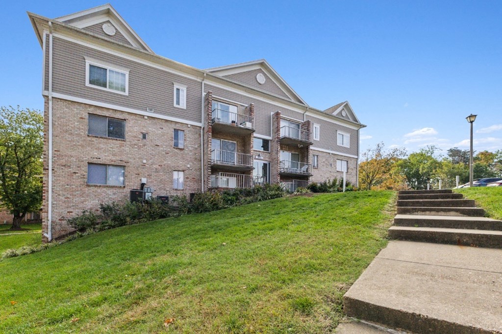 the outlook of an apartment building with stairs leading up to it at Briarwood Apartments, Dumfries, 22026