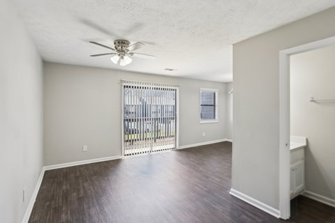 A room with a sliding door and a ceiling fan.