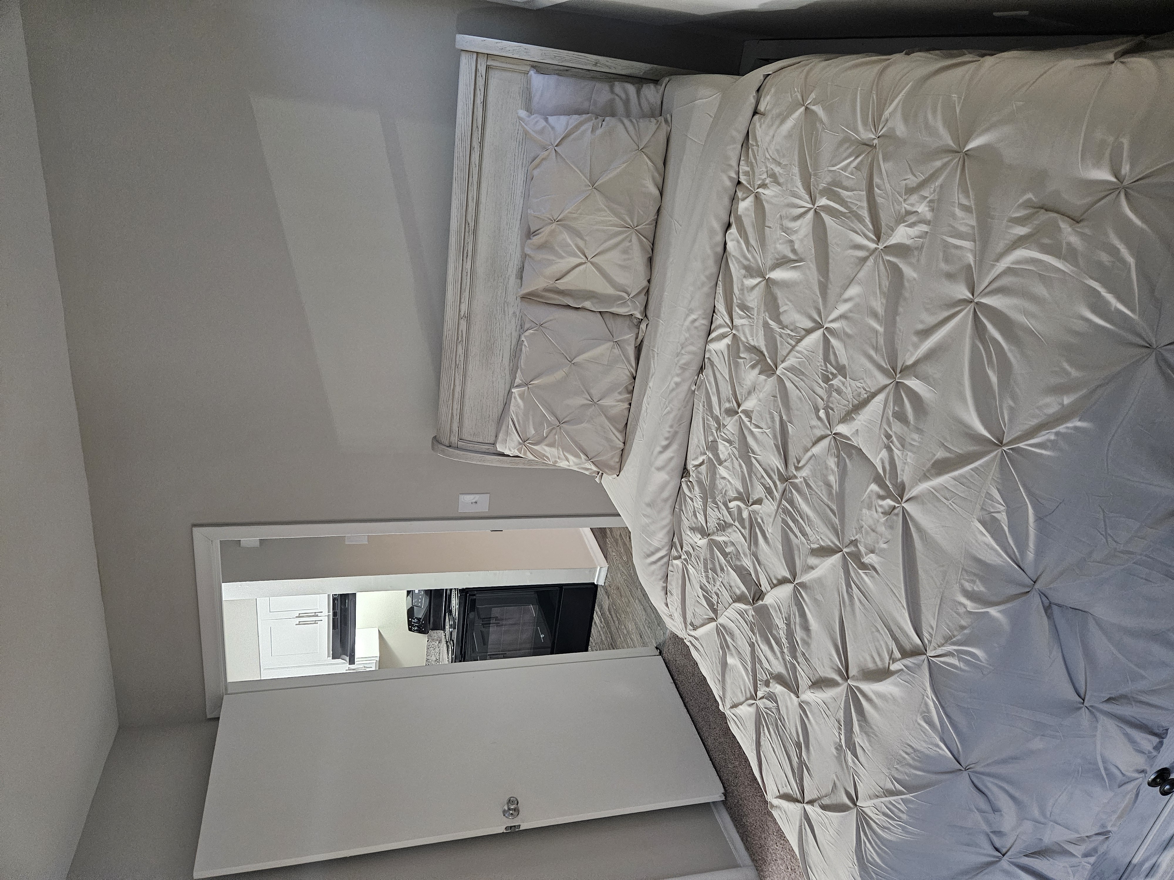 a bed and a microwave in a small room at The Flats at Talcott, Weatogue, Connecticut, 06089