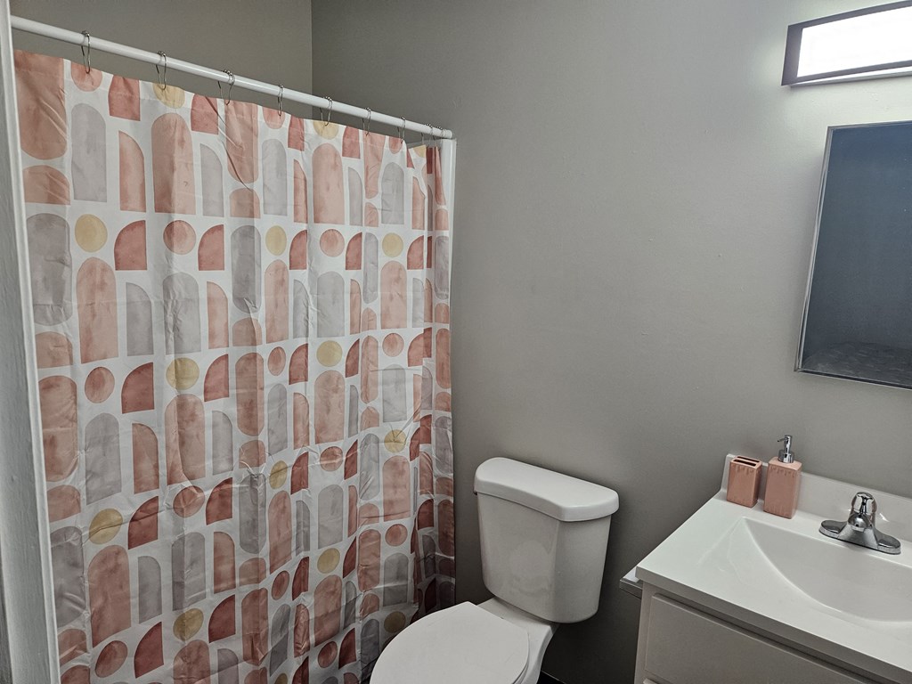 a bathroom with a shower and a toilet and a sink at The Flats at Talcott, Weatogue, Connecticut, 06089