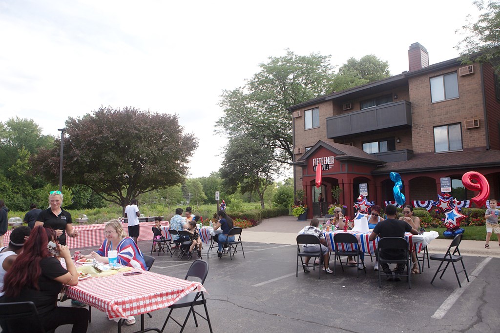 a group of people sitting at tables in front of a building