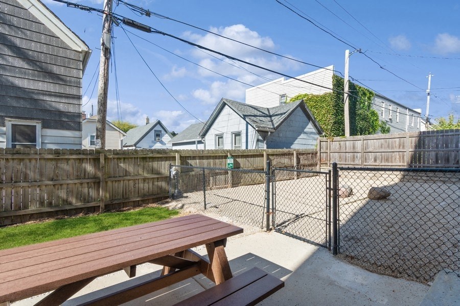 a picnic table in a fenced in area with a chain link fence